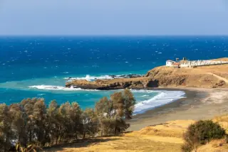 Scenic coastal view of a secluded beach with turquoise waters and rocky cliffs near Paphos, Cyprus.