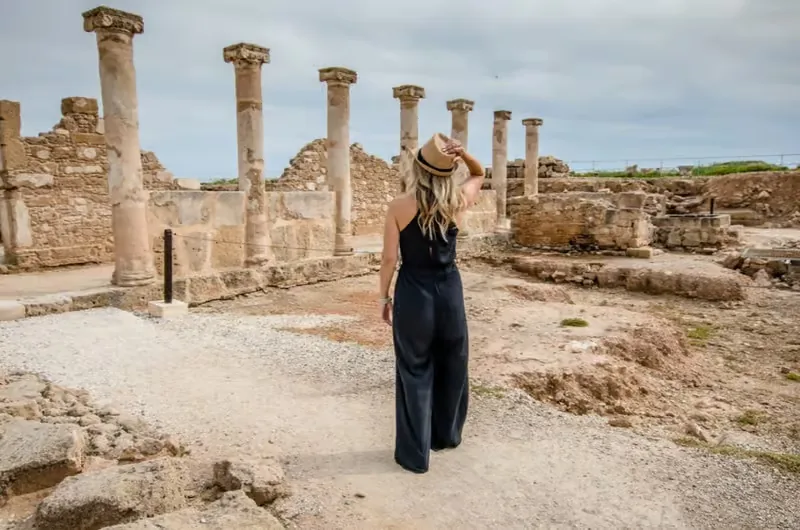 Traveller exploring the Roman columns at Kato Paphos Archaeological Park